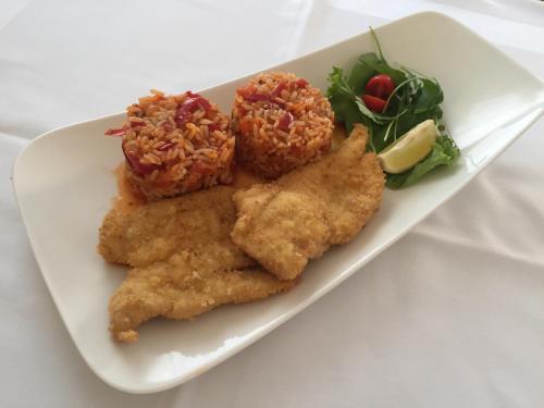 a plate of food with fried fish and a salad at Rooms & Pansion Odmor in Rovanjska