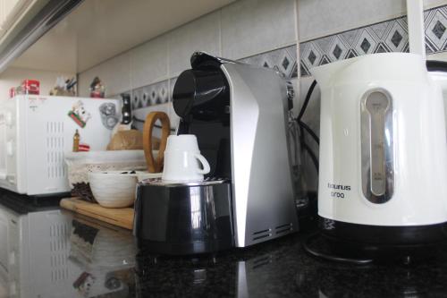 a coffee maker on a counter in a kitchen at Casa das Camélias in Aveiro