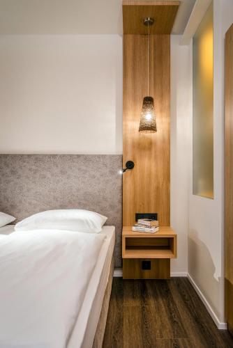 a bedroom with a bed and a table with a lamp at Botango in Parcines