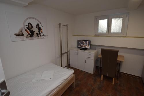 a room with a bed and a desk and a table at Apartment Terrotstraße in Stuttgart
