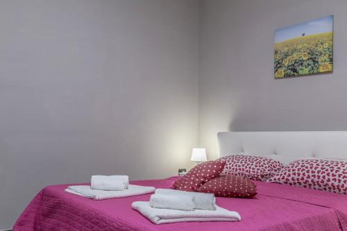 a bedroom with a purple bed with towels on it at Tufaro B&B Private Room in Macerata Campania