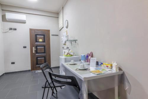 a room with a table and two chairs in it at Tufaro B&B Private Room in Macerata Campania