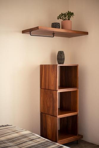 a wooden book shelf in a room with a bed at Residencia Tropical Don Bonito in Sayulita