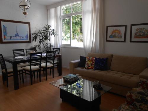 a living room with a couch and a table at Quarto Acolhedor in Salvador