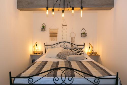 a bedroom with a bed with a black metal frame at Apartments Del Molo in Rijeka