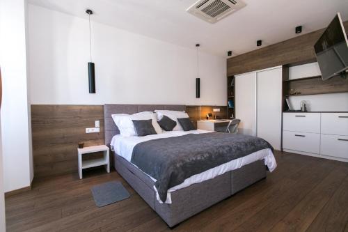 a bedroom with a bed and a dresser at Apartments Del Molo in Rijeka