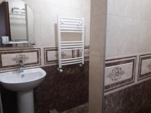 a bathroom with a sink and a mirror at Fish Hotel in Akhalk'alak'i