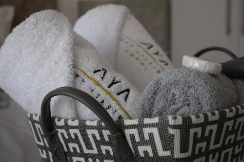a basket filled with towels and a toothbrush at Aya Luxury Apartment 84 in Durban