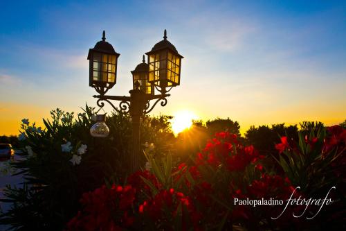 a street light with the sunset in the background at B&B Giardino Isabella in Palagiano
