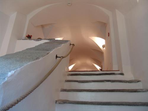 a staircase in a house with white walls at Hotel Crusch Alba Sta Maria in Sta Maria Val Müstair