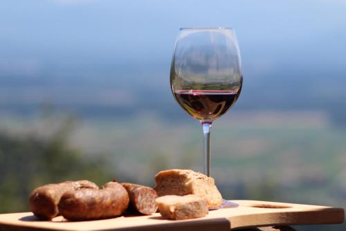 a glass of wine next to a plate of donuts at Apartma pri Boštjanu in Škofja Loka