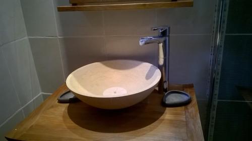 a bath tub sitting on a wooden floor in a bathroom at Maison champêtre, cheminées, vidéo projecteur, jeux in Briantes