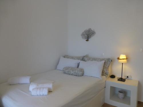 Una cama blanca con toallas en una habitación en Santorini C Villa, en Fira