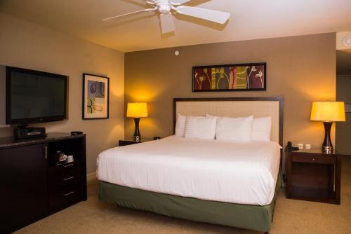 a bedroom with a bed and a flat screen tv at Isle Casino Hotel Bettendorf in Bettendorf