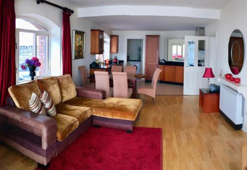 a living room with a couch and a dining room at Puffin Apartment in Valentia Island