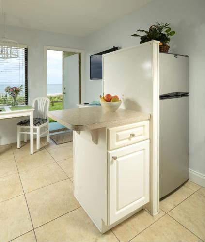 a kitchen with a white refrigerator and a bowl of fruit at Tuckaway Shores Resort in Melbourne