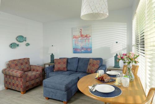 a living room with a blue couch and a table at Tuckaway Shores Resort in Melbourne