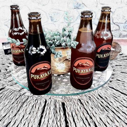 three bottles of beer sitting on a table at Casa Pukayaku Lodge in Caraz