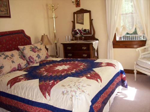 a bedroom with a bed and a dresser with a mirror at Oceanhillside B&B in Digby