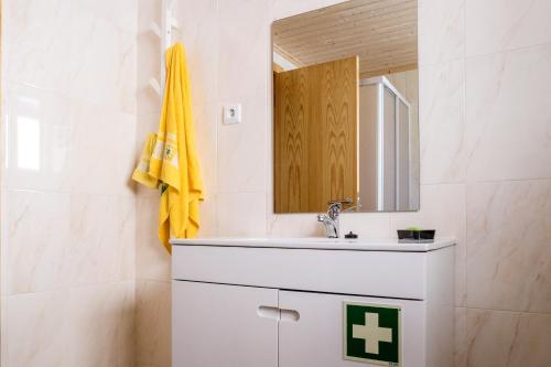 a bathroom with a sink and a mirror at Casa do Ferreiro in Góis
