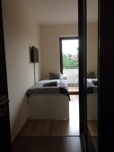 a bedroom with two beds and a window at Apartament Fibra Latte in Rybnik