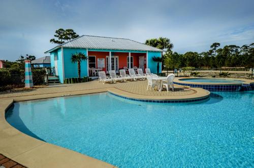 a house with a swimming pool in front of a house at The Rookery III Unit 7024 Cottage in Gulf Shores