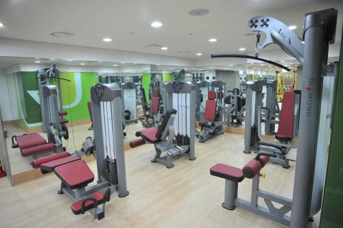 a gym with lots of treadmills and machines at Plea De Blanc Hotel & Residence in Busan