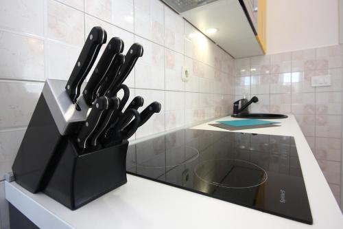 a knife block filled with knives on a counter in a kitchen at Heavenly bay in Šibenik