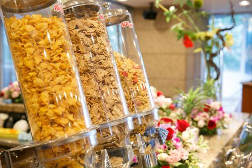 a group of containers of food on a counter with flowers at Day Nice Hotel Tokyo in Tokyo