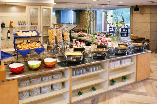 a buffet in a store with plates and food at Day Nice Hotel Tokyo in Tokyo