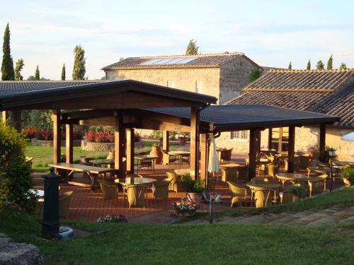 a pavilion with tables and chairs in a garden at Agriturismo La Sovana in Sarteano