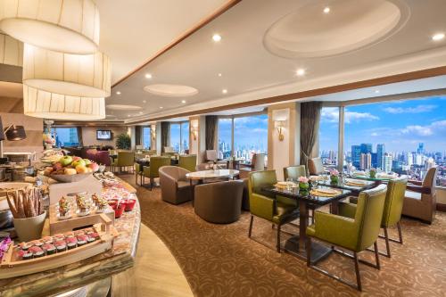 a hotel lobby with a view of the city at The Kunlun Jing An in Shanghai