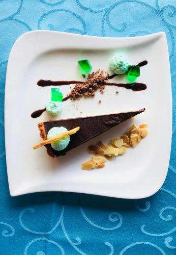 a white plate with some desserts on it at Patatran Village Hotel in La Digue