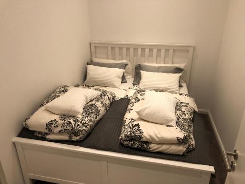 a bed with two pillows on top of it at Apartment Kornstraße in Bremen