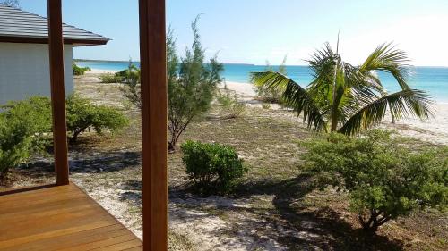 a view of the beach from the porch of a house at Hotel Paradis d'Ouvéa in Fayaoué