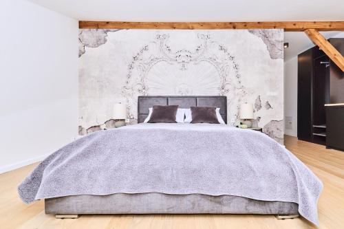 a bedroom with a bed with a gray blanket at Chodkiewicza 10 (B) - cozy studio by Homeprime in Krakow