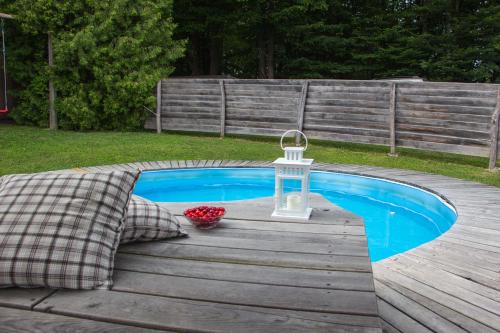 a small pool with a lantern on a wooden deck at Log cabin Silec in Šmarje pri Jelšah