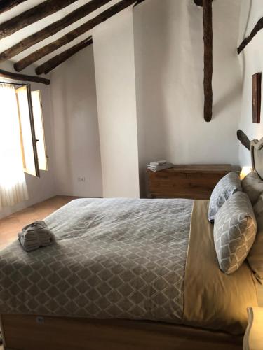 a bedroom with a large bed with pillows on it at El Portal de Moratalla in Moratalla
