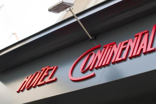 a sign on a building that says all original at Hotel Continental in Angers