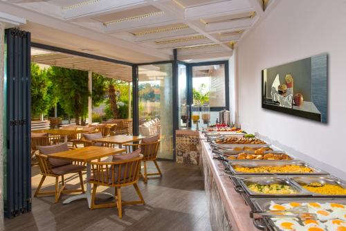 a buffet line with many plates of food at Senses Blue Boutique hotel in Hersonissos