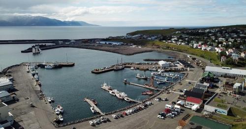 an aerial view of a harbor with boats in the water at Askja Apartment in Húsavík