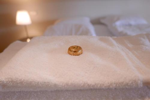 a ring sitting on top of a bed at Askja Apartment in Húsavík