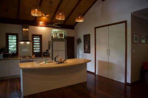 a kitchen with a large island in the middle of it at Treetops Retreat Cairns in Cairns