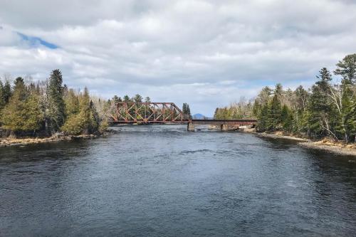 a train bridge over a river with trees at Pebble Cove in The Highlands