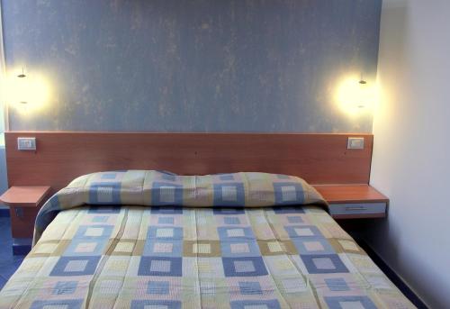 a bedroom with a bed with two lights on the wall at MeFra Camere - Amalfi Coast in Atrani