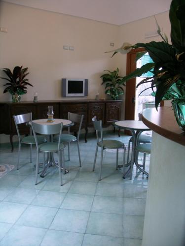 a dining room with tables and chairs and a tv at MeFra Camere - Amalfi Coast in Atrani