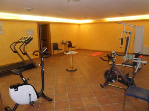 a gym with bikes and exercise equipment in a room at Cà Rocca Relais in Monselice