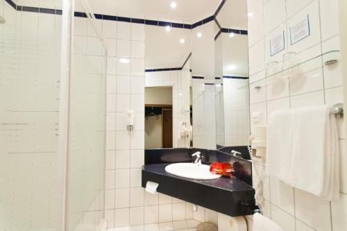 a bathroom with a sink and a shower at Express Kraków Hotel in Krakow