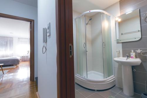 a bathroom with a shower and a sink at Tea Studio Apartments in Niš
