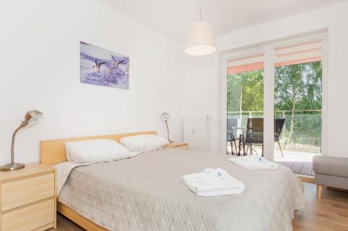 Posteľ alebo postele v izbe v ubytovaní Apartamenty Polanki Park BASEN, SAUNA & SIŁOWNIA by Noclegi Renters